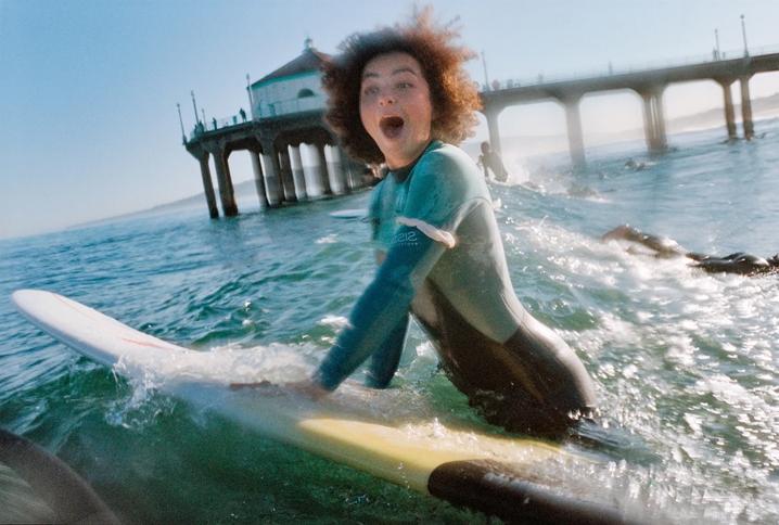 Surfer making a look of shock as they get wet